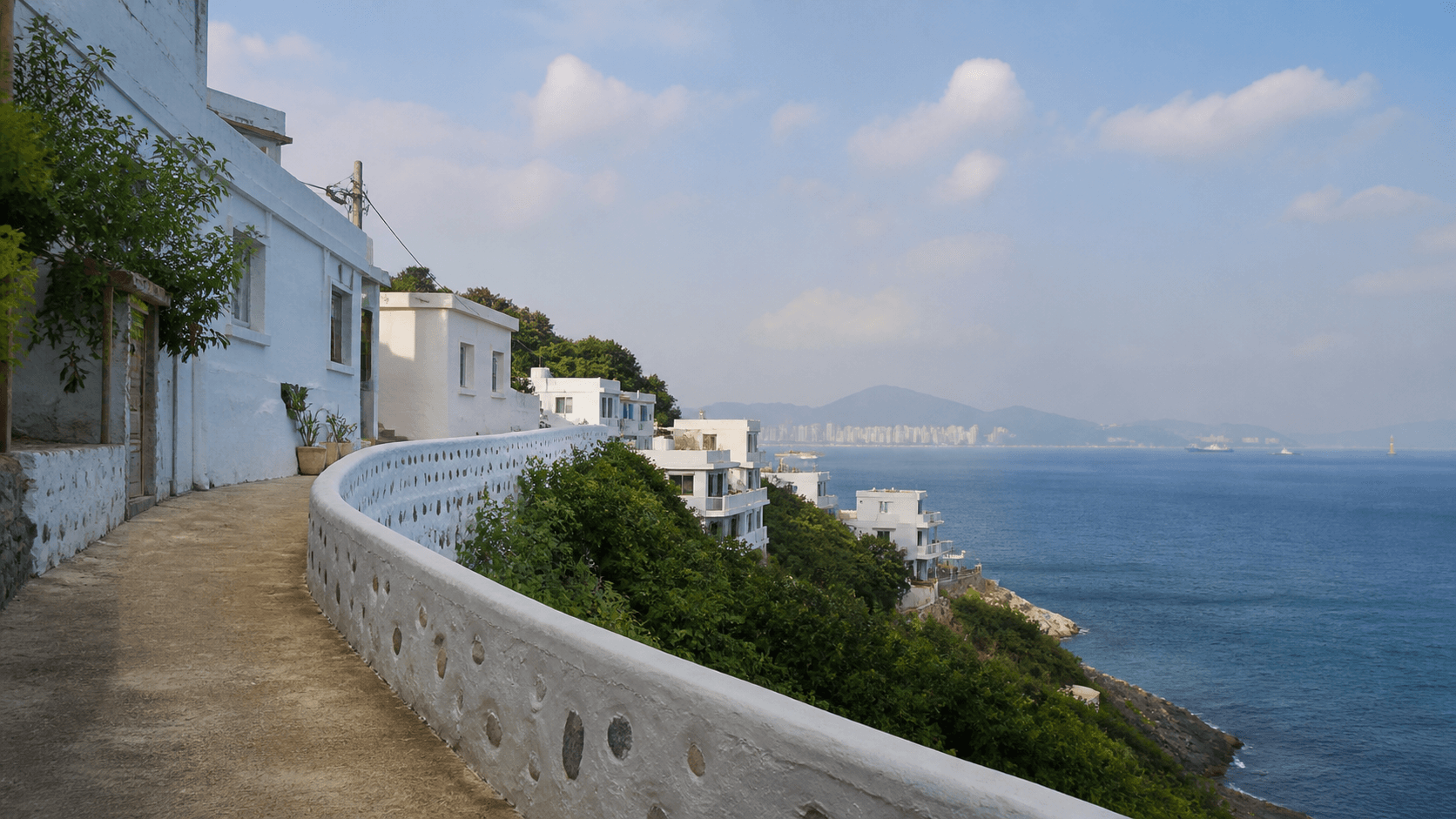 White coastal village and walking path inspired by Huinnyeoul